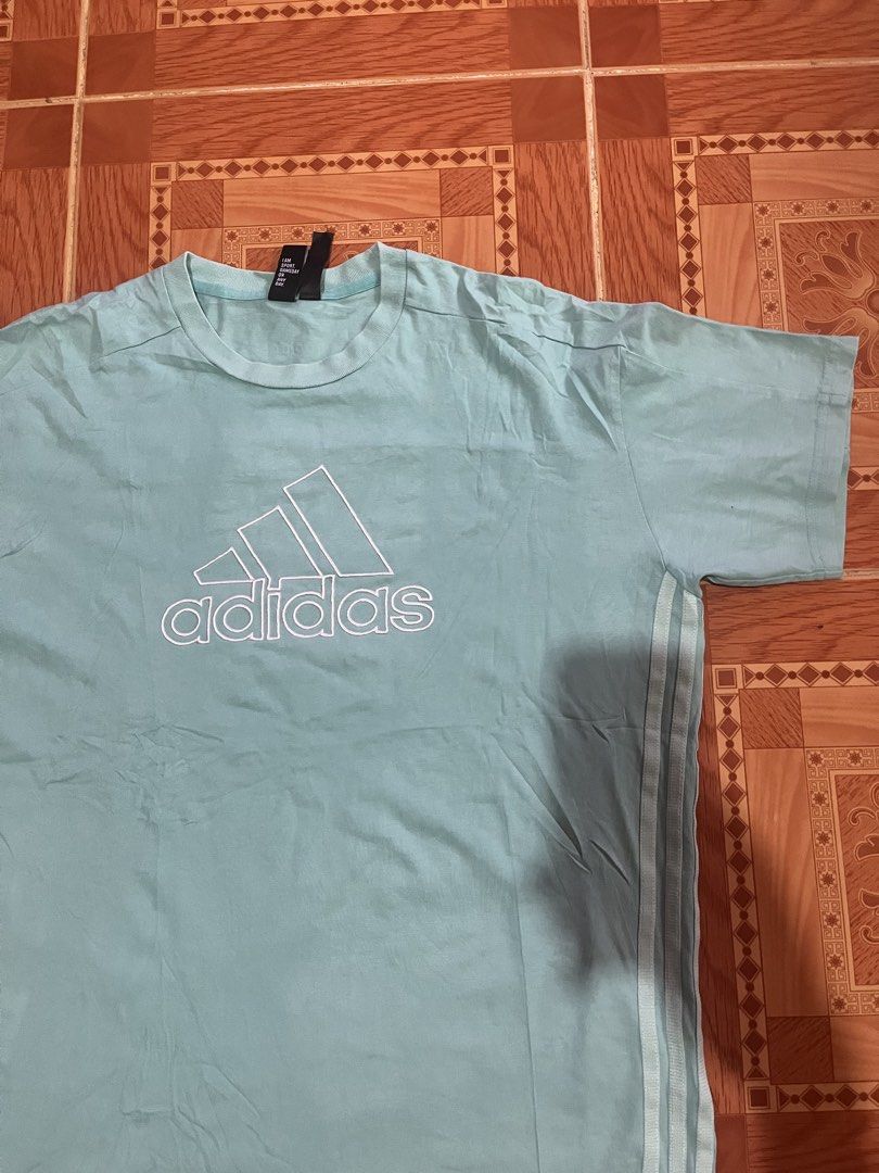 Adidas light blue t-shirt with logo (Category: Tshirts & Polo Shirts ) located in Kidapawan. Submitted by azythrift (Listing ID 1470821795, Image 2). Description: - Brand: Adidas - Color: Light Blue - Size: Large - Design: Large outlined Trefoil logo on chest & classic three stripes on sleeves - Details: Ribbed crew neck, 'I AM SPORT' inner collar tag - Material: Comfortable, breathable cotton.
