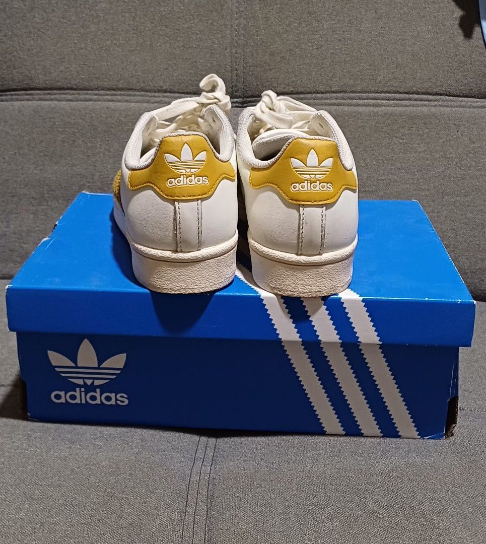 Adidas Superstar Off White Leggld (Category: Sneakers) located in Bacoor. Submitted by paupikoyz (Listing ID 1470852011, Image 3). Description: - Brand: Adidas Superstar - Colorway: Off-white and gold with stylish suede stripes and heel patch - Bought in Fukouka, Japan - Size: US 4.5 / UK 4 / EUR 36 - Condition: Super clean uppers and soles. - Inclusion: Complete with original blue Adidas box - Perfect for daily wear and easy to match with any ou