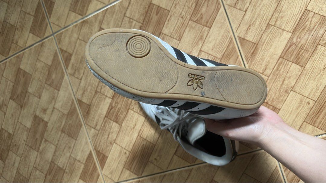 Adiddas Taekwondo (Category: Sneakers) located in Taguig. Submitted by prettymaiden1998 (Listing ID 1470777427, Image 3). Description: - Brand/Model: taekwond lace - Color: Classic White and Black with iconic three stripes - Size: US 6.5 / UK 5 / FR 38 - Sole: Gum rubber with excellent grip pattern - Comfort: Padded collar and tongue - Origin: Made in Cambodia - Condition: Clean inside and out, minor wear on soles Rfs: Too big and declutter. 1 ye