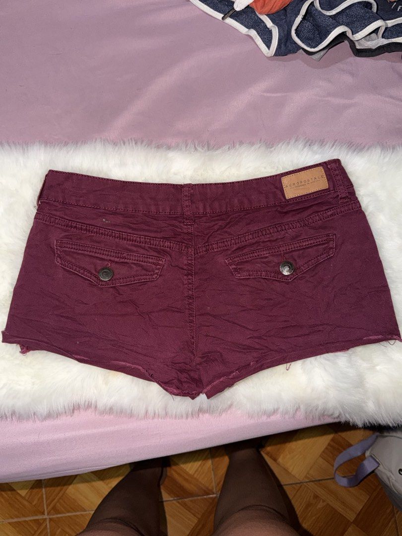 Aeropostale Maroon Cargo Denim Shorts (Category: Shorts) located in Manila. Submitted by maureenn10 (Listing ID 1470841770, Image 2). Description: - Brand: Aéropostale - Color: Maroon - Style: Mid-rise denim shorts with raw hem edges - Pockets: Multiple functional button-flap pockets on front and back - Details: Leather brand patch on back waistband - Closure: Zip fly with metal button - Condition: Excellent / Ready to wear - Perfect for casual O