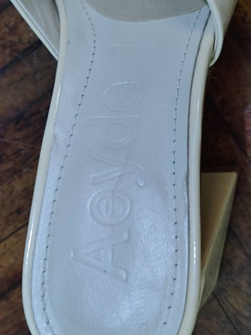 Aeyde Cream Mules Block Heels Square Toe (Category: Heels) located in Bacoor. Submitted by stargazer1084 (Listing ID 1470836514, Image 2). Description: - Brand: Aeyde - Style: Cream mules / slip-on heels - Design: Square toe with wide upper strap and chunky block heel - Details: Debossed logo on insole - Condition: Minimal wear on the soles, well-maintained - Color: Versatile clean neutral shade.