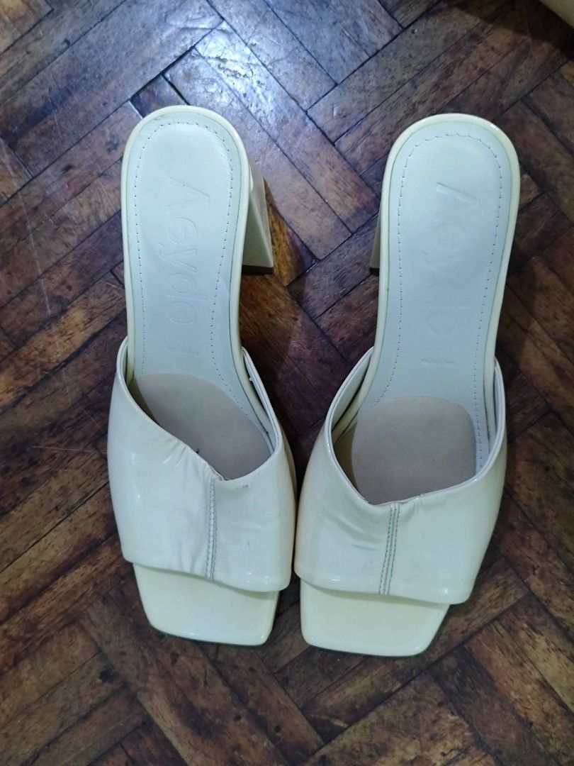 Aeyde Cream Mules Block Heels Square Toe (Category: Heels) located in Bacoor. Submitted by stargazer1084 (Listing ID 1470836514, Image 1). Description: - Brand: Aeyde - Style: Cream mules / slip-on heels - Design: Square toe with wide upper strap and chunky block heel - Details: Debossed logo on insole - Condition: Minimal wear on the soles, well-maintained - Color: Versatile clean neutral shade.