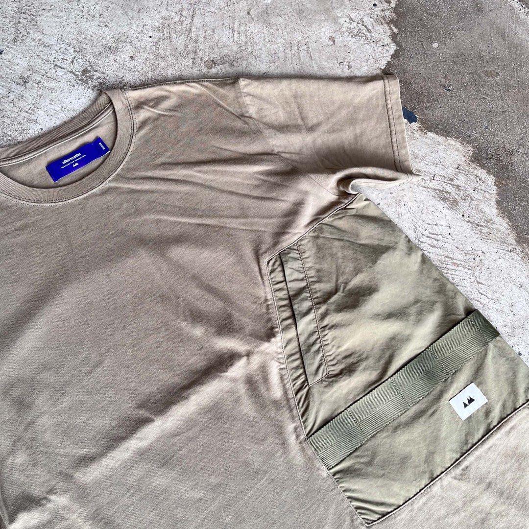 Aftermaths tee (Category: Tshirts & Polo Shirts ) located in Caloocan City. Submitted by landcruiser76__ (Listing ID 1470874134, Image 3). Description: - Brand: Aftermaths - Color: Taupe / Khaki with purple interior neck tag - Size: Medium - Material: Heavyweight cotton with clean construction - Design: Tactical utility chest pocket wrapping around to the back - Details: Features strap webbing and a small logo patch - Cut: Crew neck, short sleeve
