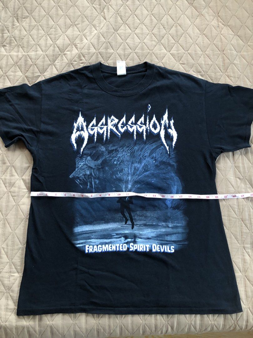 Aggression Fragmented Spirit Devils Band T-Shirt (Category: Tshirts & Polo Shirts ) located in Talisay. Submitted by mojojodro76 (Listing ID 1470848276, Image 2). Description: - Brand: Aggression (Band Merch) - Tag: Gildan Heavy Cotton - Size: Large - Color: Black with blue and white artwork - Graphics: 'Fragmented Spirit Devils' (front) / 'Unleashing the ghost' (back) - Pit to pit: ~21 inches - Total length: ~29 inches - Condition: Solid conditi