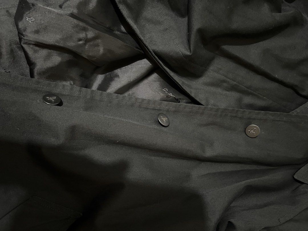 Agnes b. Black Trench Coat Size 36 (Category: Coats, Jackets and Outerwear) located in Balanga. Submitted by clscloset.621 (Listing ID 1470754819, Image 3). Description: - Brand: Agnes b. Paris - Size: 36 - Color: Classic black - Design: Button front closure, structured collar, and clean back vent - Details: Long sleeves with buckle straps at the cuffs, deep front pockets - Lining: Fully lined with subtle logo embroidery throughout - Condition/St