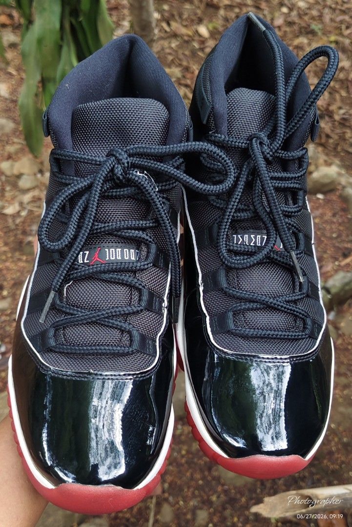 Air Jordan 11 Retro Bred (Category: Sneakers) located in Manila. Submitted by sansmerci27 (Listing ID 1470899017, Image 2). Description: - Model: Air Jordan 11 Retro - Colorway: Iconic Black and Red (Bred) - Details: Glossy patent leather mudguard, black mesh upper, matching rope laces - Soles: White midsole with bright red outsole - Branding: Red embroidered Jumpman logo near the ankle - Condition: Great addition to any sneaker rotation - Meetup