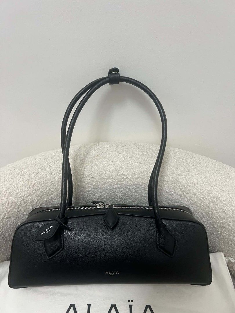 Alaïa East West Leather Shoulder Bag (Category: Shoulder Bags) located in Paoay. Submitted by rvf1230 (Listing ID 1470818323, Image 3). Description: - Brand: Alaïa - Material: Premium black leather - Style: Sleek horizontal shoulder bag with dual top handles - Hardware: Silver-tone with secure zip closure and double pullers - Condition: Pristine, clean exterior - Inclusions: Original box and dust bag included.