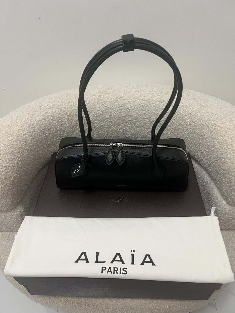 Alaïa East West Leather Shoulder Bag (Category: Shoulder Bags) located in Paoay. Submitted by rvf1230 (Listing ID 1470818323, Image 2). Description: - Brand: Alaïa - Material: Premium black leather - Style: Sleek horizontal shoulder bag with dual top handles - Hardware: Silver-tone with secure zip closure and double pullers - Condition: Pristine, clean exterior - Inclusions: Original box and dust bag included.