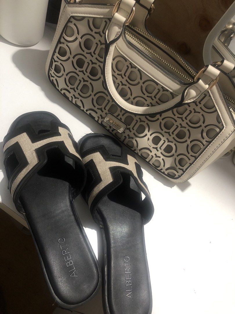 Alberto Handbag and Sandals Set Size 37 (Category: Flats & Sandals) located in Manila. Submitted by camron08 (Listing ID 1470879792, Image 1). Description: - Brand: Alberto matching set - Handbag: Structured cream handbag with cut-out pattern, twin zipper compartments, top handles, and metal hardware - Footwear: Black and beige slide sandals with geometric H-strap design, flat soles, and slip-on style (Size 37) - Inclusions: Original white Albert
