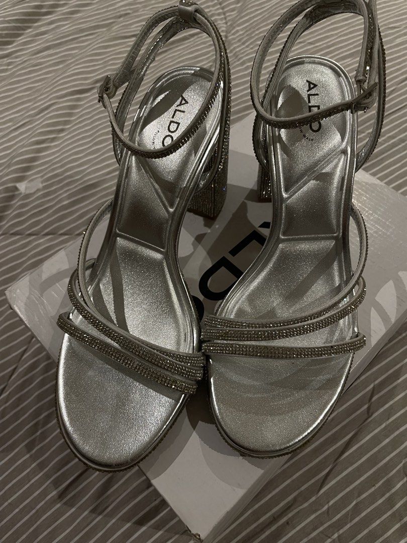 ALDO Chicglow Silver Rhinestone Block Heels (Category: Heels) located in Manila. Submitted by franceshous (Listing ID 1470752779, Image 2). Description: - Brand: ALDO with dust bag and box - Style: Silver rhinestone-covered block heels with ankle strap buckle closure - Size: US 7.5 / EUR 38 / UK 5 - Inclusions: Comes with original ALDO shoe box - Occasion: Ideal for parties, weddings, and nights out - Condition: Excellent.