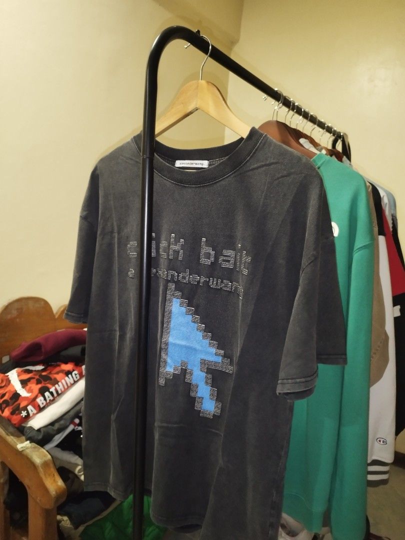 Alexander Wang Click Bait Graphic Tee (Category: Tshirts & Polo Shirts ) located in Tuguegarao City. Submitted by ZeevLim (Listing ID 1470926832, Image 1). Description: - Brand: Alexander Wang - Color: Dark Grey acid wash - Size: S 22w 28l - Material: 100% Cotton - Design: Pixelated blue mouse cursor graphic with 'click bait' text - Details: Crew neck, ribbed neckline, clean stitching throughout - Fit: Comfortable and easy to style for casual wea