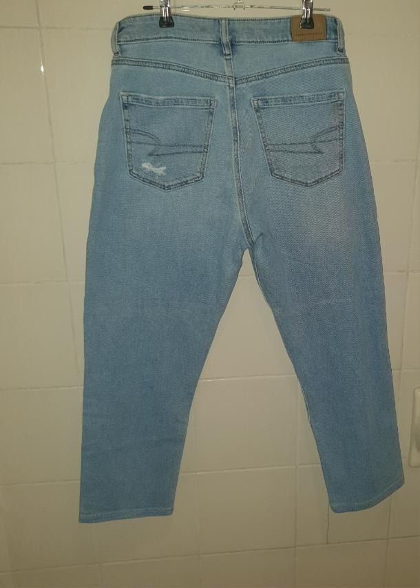American Eagle Stretch Mom Jean (Category: Jeans) located in Caloocan City. Submitted by mma_222 (Listing ID 1470845525, Image 2). Description: - Brand: American Eagle (Real Good line) - Classic mom jean, high-waisted fit - Waist: 31 inches - Length [waist to hem]: 34 inches - Wash: Light wash denim with comfortable stretch - Details: Intentional distressing on the front and back pocket, standard belt loops, and leather brand patch on the back wa