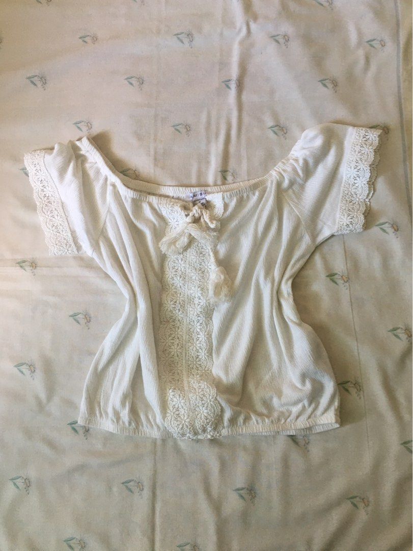 AMISU White Off-Shoulder Lace Blouse (Category: Blouses) located in Cabuyao City. Submitted by 4everblooms (Listing ID 1470773811, Image 1). Description: - Size: Medium (fabric is stretchable) - Material/Origin: Made in Bangladesh - Design: Off-shoulder with gathered elastic neckline and hem - Beach summer vibes.