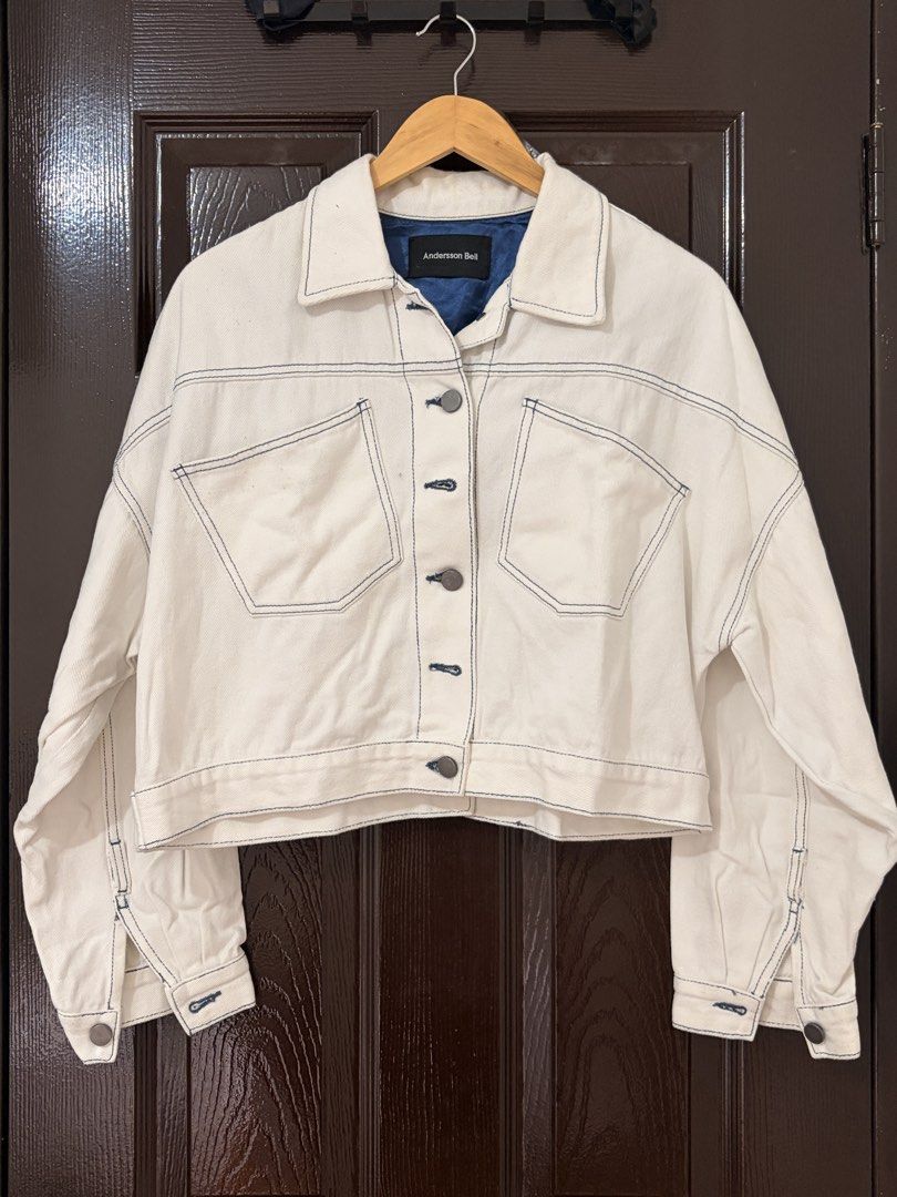 Andersson Bell White Denim Crop Jacket (Category: Coats, Jackets and Outerwear) located in Marikina City. Submitted by _bananahanaa (Listing ID 1470802472, Image 1). Description: - Brand: Andersson Bell - Color: White with contrast blue stitching and bright blue inner lining - Fit: Trendy cropped cut - Details: Oversized chest pockets, front button closure, and a unique split detail at the back - Condition: Good, with minor yellowing around the i