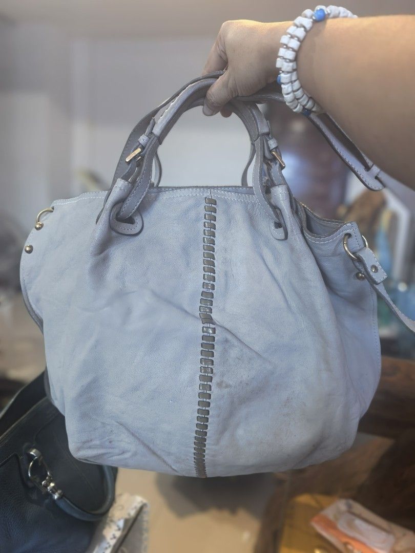 Andrea Mabiani Grey Leather Bag (Category: Luxury Bags & Wallets) located in Cagayan de Oro. Submitted by tommygurl1218 (Listing ID 1470800901, Image 2). Description: - Brand: Andrea Masiani - Style: Slouchy hobo shoulder bag - Color: Grey leather with gold-tone hardware - Design: Unique vertical whipstitch detail down the middle - Straps: Two comfortable woven shoulder straps - Interior: Spacious with a zip pocket and leather branding - Conditio