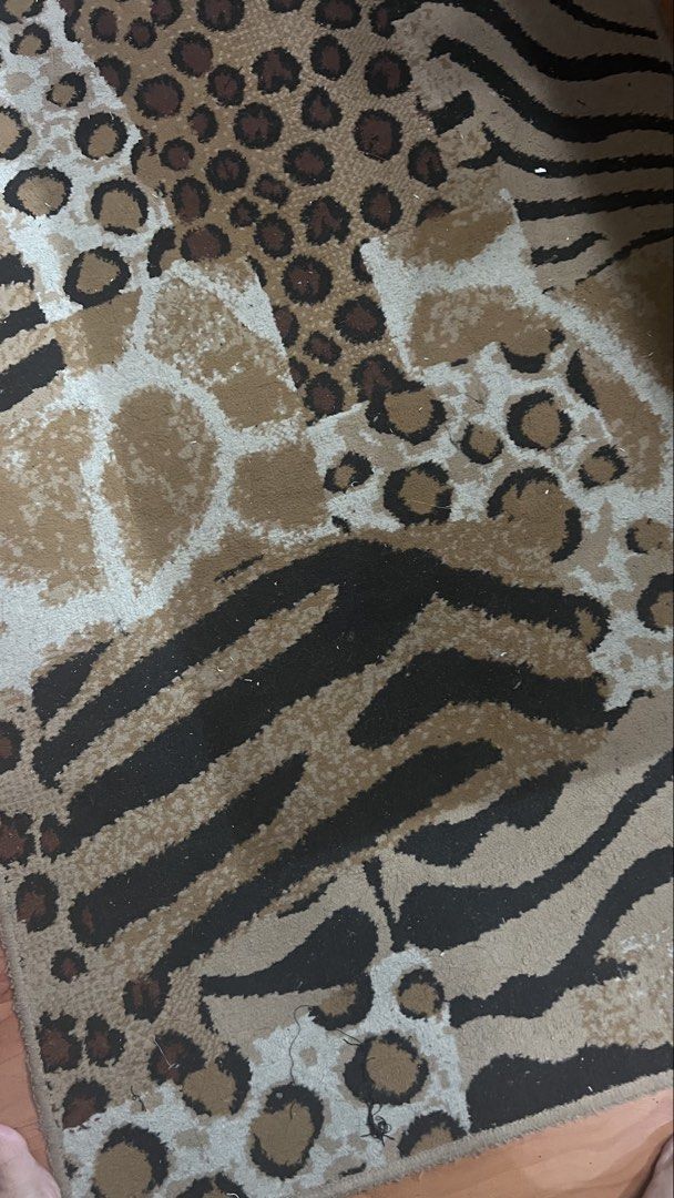 Animal print area rug leopard zebra giraffe pattern (Category: Carpets, Mats & Flooring) located in Pasig City. Submitted by zebteashoppe01 (Listing ID 1470853684, Image 3). Description: - Design: Mixed animal prints (leopard, zebra, and giraffe) - Colors: Stylish brown, black, and beige tones - Texture: Soft pile texture for comfort underfoot Size lenght 58 inches Width 31inches - Placement: Decent size, perfect for bedrooms or living rooms - Ca