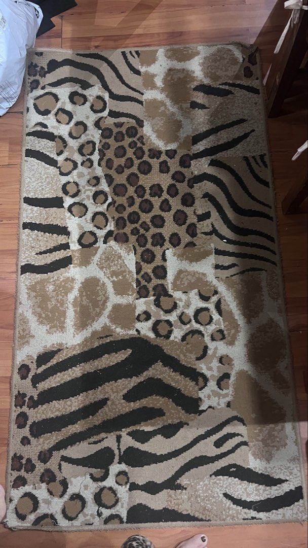 Animal print area rug leopard zebra giraffe pattern (Category: Carpets, Mats & Flooring) located in Pasig City. Submitted by zebteashoppe01 (Listing ID 1470853684, Image 1). Description: - Design: Mixed animal prints (leopard, zebra, and giraffe) - Colors: Stylish brown, black, and beige tones - Texture: Soft pile texture for comfort underfoot Size lenght 58 inches Width 31inches - Placement: Decent size, perfect for bedrooms or living rooms - Ca