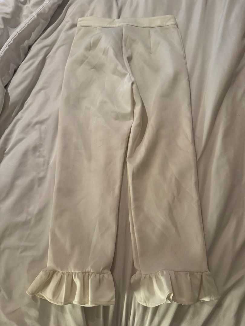 Apartment Eight White Ruffle Hem Pants Size S (Category: Jeans) located in Cebu City. Submitted by _t.rix (Listing ID 1470762237, Image 1). Description: - Brand: Apartment Eight - Size: Small - Color: Clean White - Details: Cute ruffled hems, tailored waistline, side zip closure - Style: Versatile for casual days or dressed up events - Condition: Excellent.
