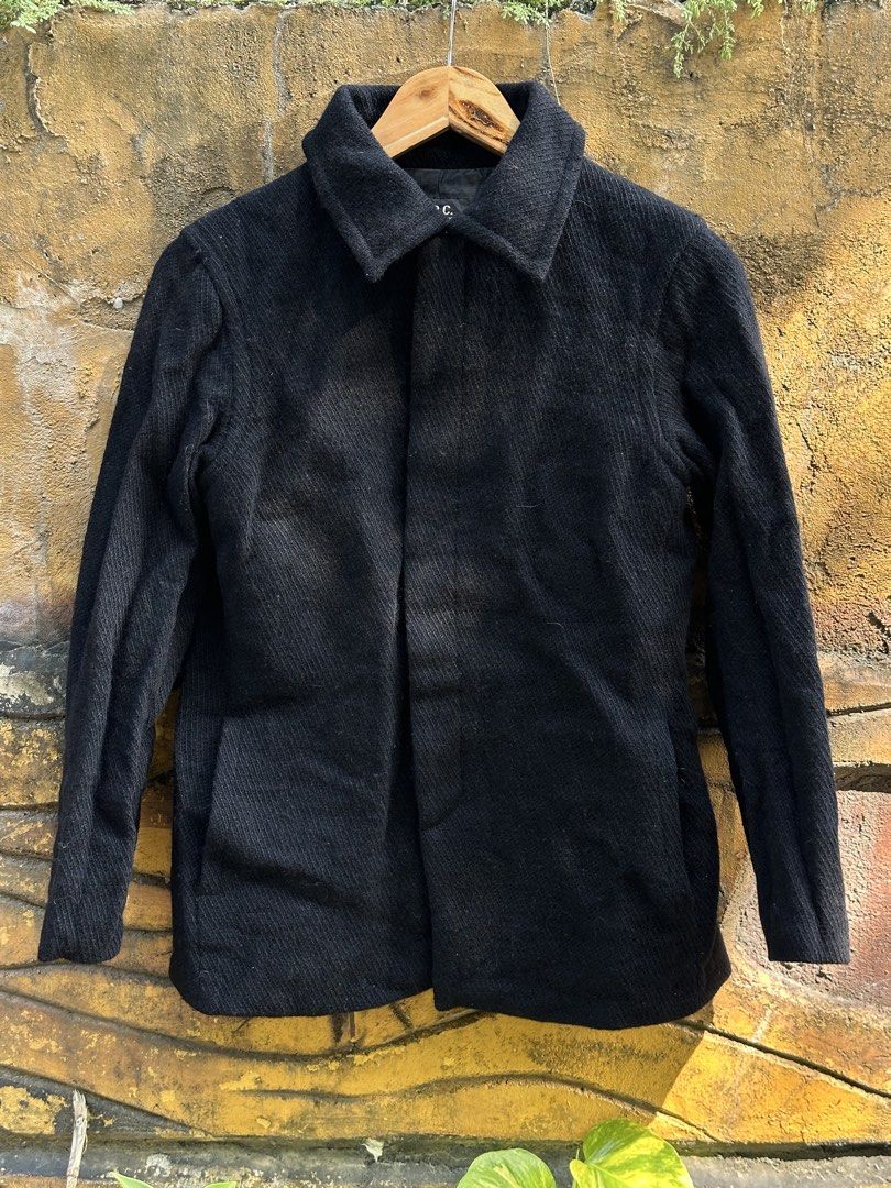 A.P.C. Paris Black Wool Textured Hidden Button Coat (Category: Coats, Jackets and Outerwear) located in Urdaneta. Submitted by redeemedcollective (Listing ID 1470868432, Image 1). Description: A.P.C. Paris Wool Coat Minimalist black wool coat from French fashion label A.P.C., featuring a textured exterior, structured collar, and concealed front button closure. • Black textured wool exterior • 100% wool • Made in France • Concealed button-front cl