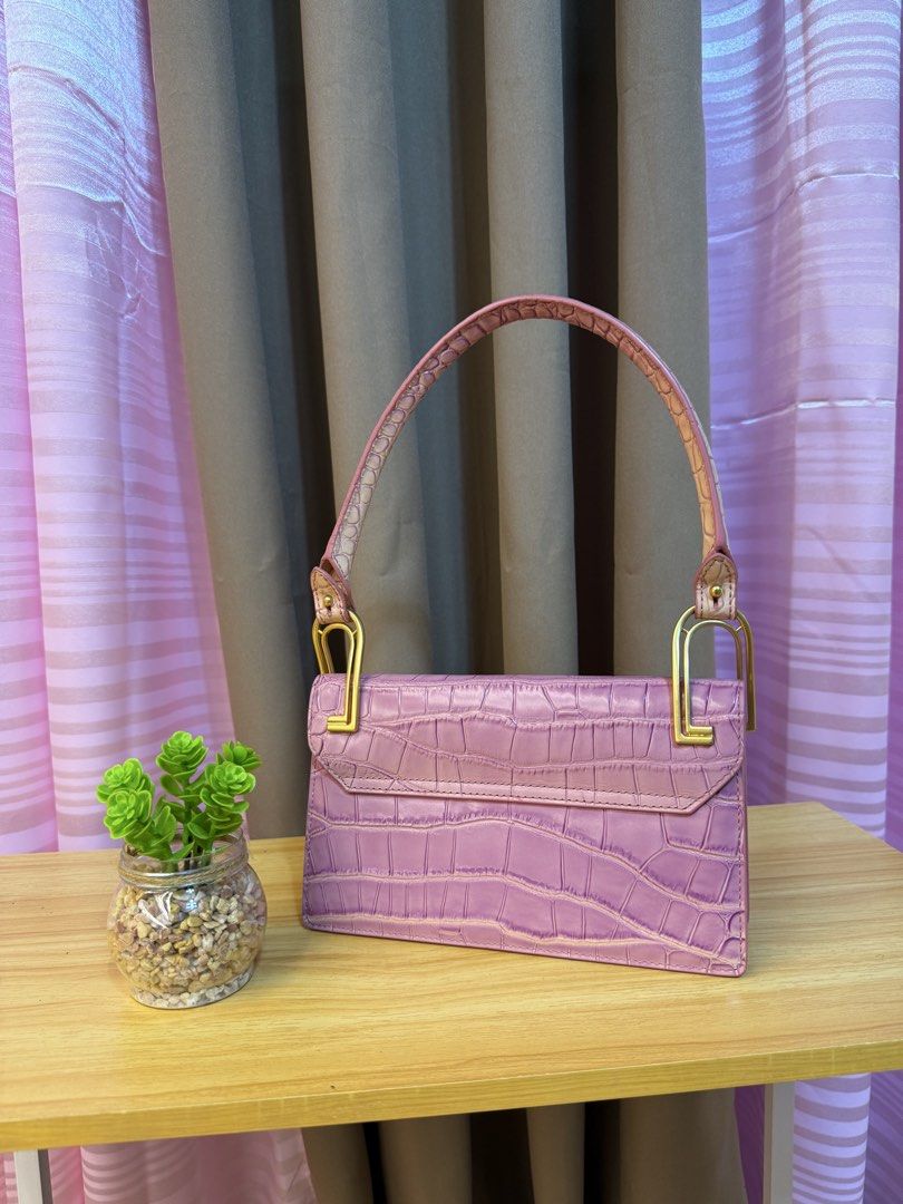 Apede Crocodile Embossed Shoulder Bag (Category: Shoulder Bags) located in Davao. Submitted by prince051097 (Listing ID 1470864031, Image 2). Description: - Color & Finish: Rich purple with a chic crocodile embossed texture - Design: Structured rectangular shape with an elegant top handle - Hardware: Premium gold-tone accents with a secure turn-lock flap closure - Interior: Smooth lining featuring a convenient slip pocket - Condition: Clean struc
