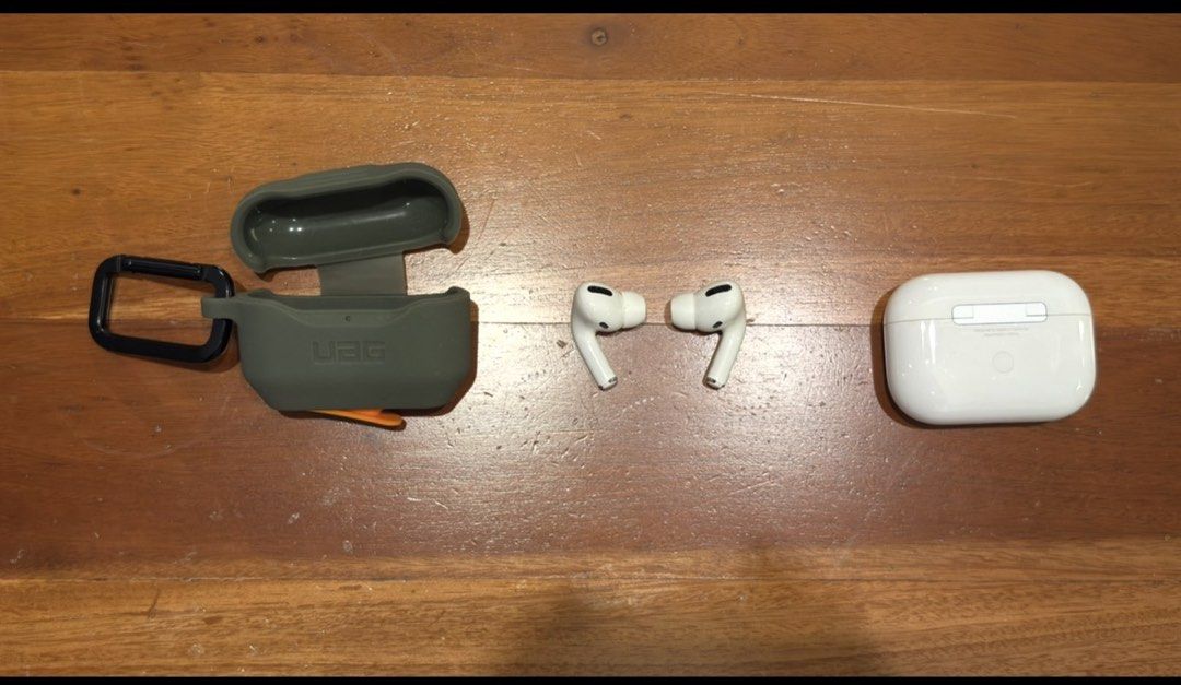 Apple AirPods Pro with UAG protective case (Category: Headphones & Headsets) located in Taguig. Submitted by s.tree (Listing ID 1470831818, Image 1). Description: Details: • Brand: Apple • Model: AirPods Pro 1st Generation • Model Number: A2084 • Color: White • Condition: Good, with normal signs of use • Includes original Apple charging case • Includes original UAG green protective case • Battery condition: Not recently tested • Original box: Sti