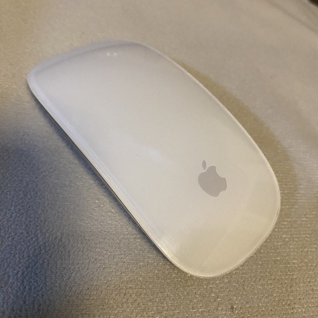 Apple Magic Mouse Model A1657 (Category: Mouse & Mousepads) located in Santa Rosa. Submitted by dasha07 (Listing ID 1470869755, Image 1). Description: - Model: Apple Magic Mouse A1657 - Condition: Fully functional, connects seamlessly via Bluetooth - Design: Silver aluminum base with a clean white top surface and Apple logo - Power: Rechargeable battery with port located underneath - Flaws: Bottom shows standard wear and tear with peeling on the 