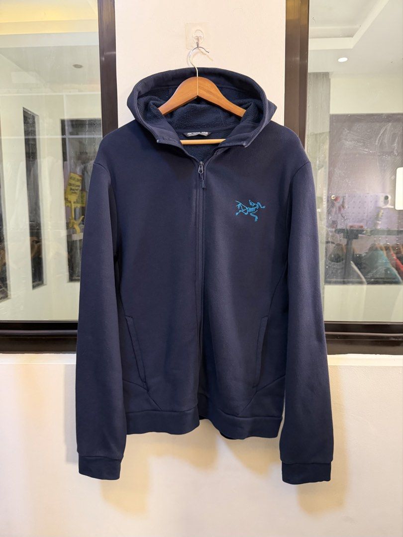 Arc’teryx Full-Zip Hooded Jacket (Category: Coats, Jackets and Outerwear) located in Paranaque City. Submitted by preluxeshop_ph (Listing ID 1470814655, Image 2). Description: Brand: Arc’teryx •Style: Full-Zip Hooded Jacket / Fleece Hoodie •Color: Dark Navy Blue with contrasting light blue embroidered Arc’teryx logo on the chest •Design Features: Attached hood, full front zip closure, front hand pockets, and textured inner fleece lining •Tag Size