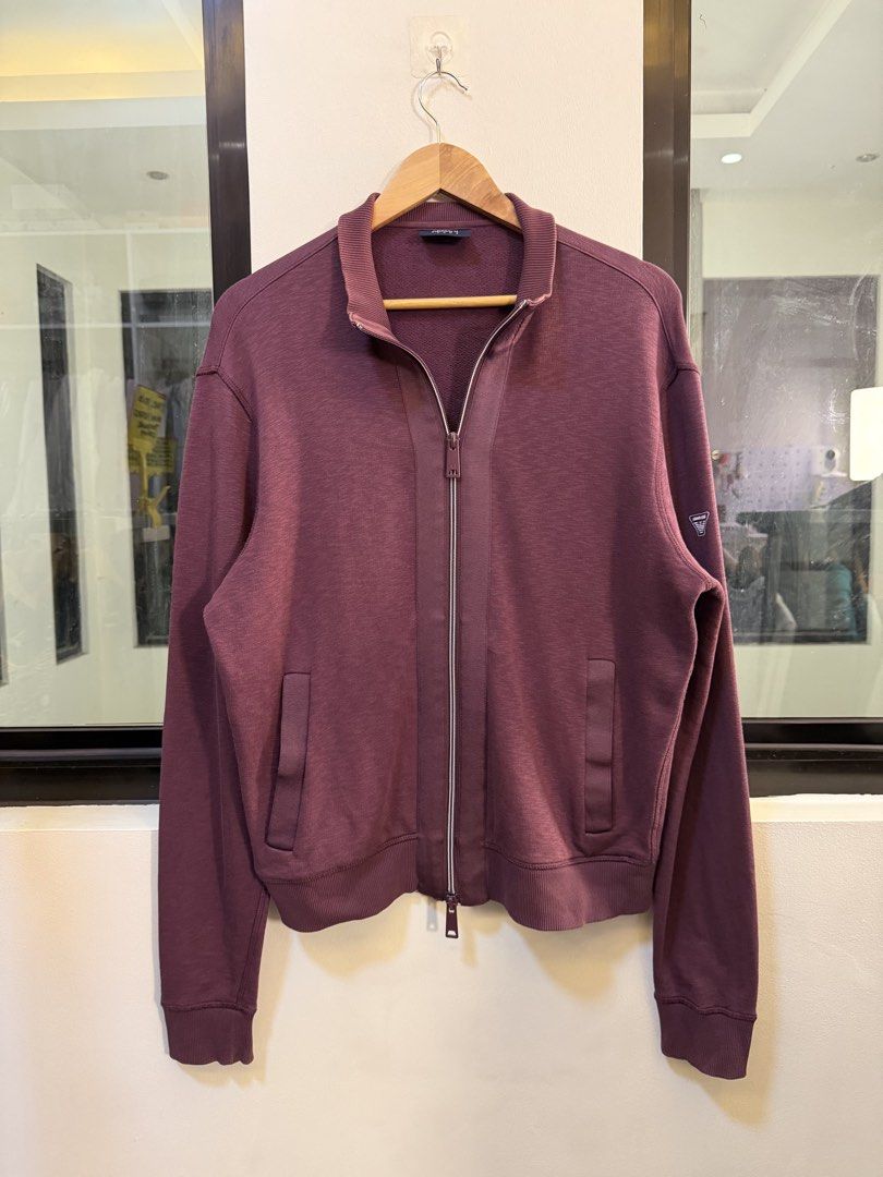 Armani Jeans Full-Zip Track Jacket (Category: Coats, Jackets and Outerwear) located in Paranaque City. Submitted by preluxeshop_ph (Listing ID 1470818686, Image 2). Description: Brand: Armani Jeans •Style: Full-Zip Track Jacket / Stand-Collar Sweatshirt •Color: Plum / Maroon •Design Features: Full front zip closure, stand-up collar, side welt pockets, and ribbed cuffs and hem •Tag Size: Extra Large (XL) / 185/104A •Condition: Pre-loved / Good as 