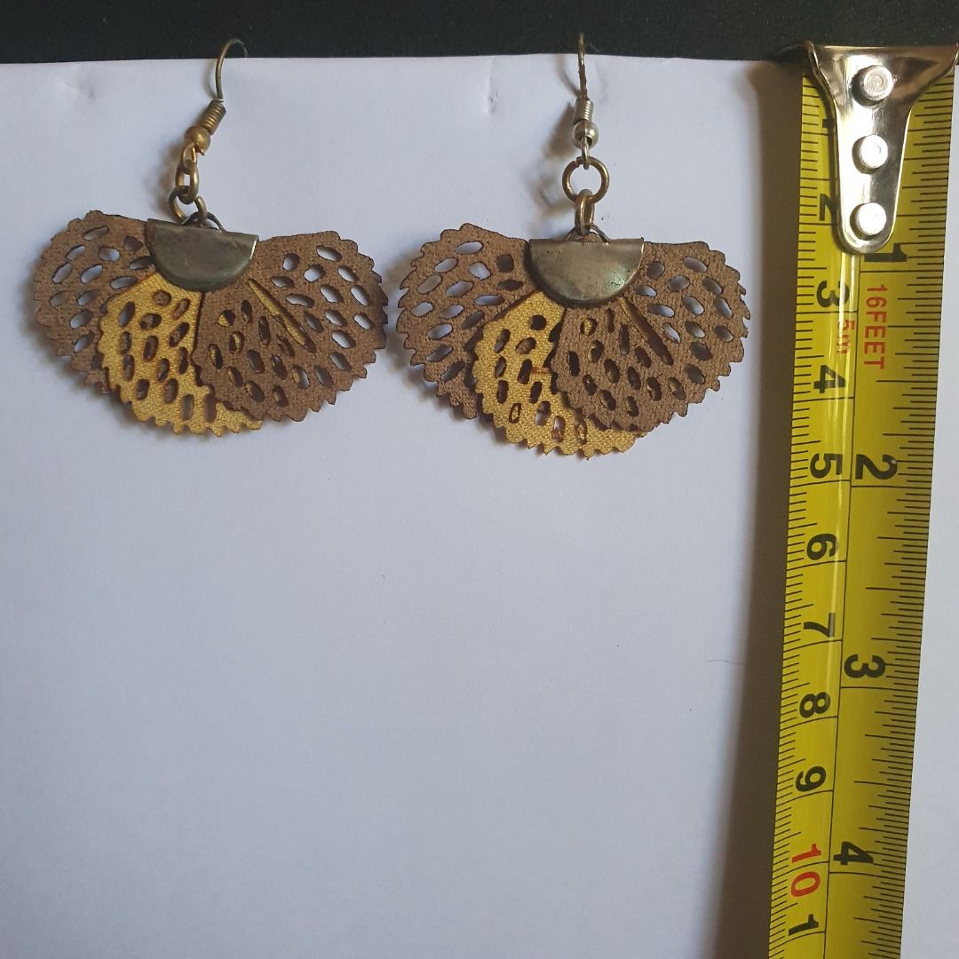 Assorted Fashion Earrings Bundle Set Php 100 (Category: Earrings) located in Caloocan City. Submitted by mma_222 (Listing ID 1470858276, Image 2). Description: - Bundle of 3 distinct pairs of statement earrings - Pair 1: Black faceted drops with faux pearl accents in copper-tone hardware - Pair 2: Layered fan-shaped perforated leaf designs in warm brown and yellow tones - Pair 3: Light blue translucent stone-like beads on silver hooks - Tomas Mor