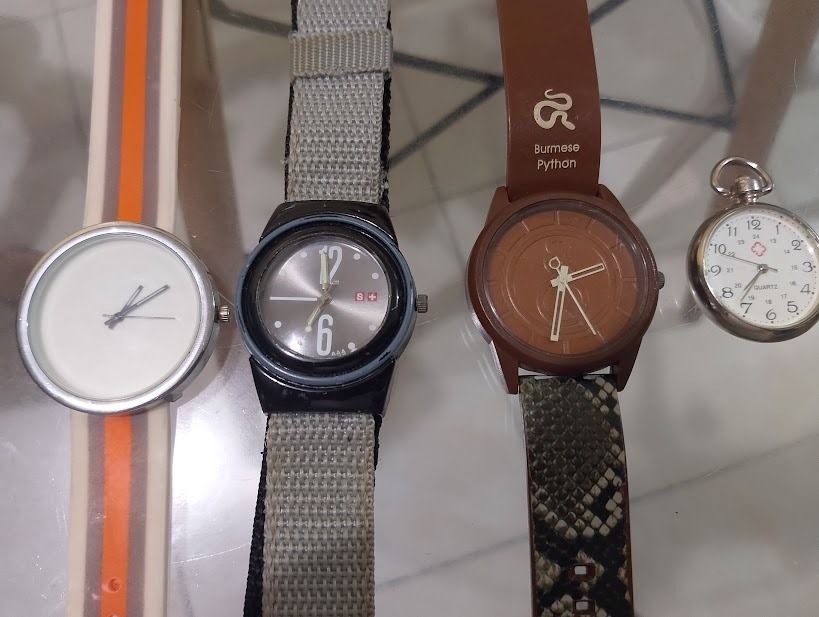 Assorted Wristwatches and Pocket Watch Bundle (Category: Men's Watches) located in Quezon City. Submitted by susmaryosep1 (Listing ID 1470789753, Image 2). Description: - Bundle of 4 diverse watches sold together as a complete set - 1x Striped silicone strap watch for casual wear - 1x Black tactical watch with a durable grey fabric strap - 1x Brown Burmese Python watch featuring a textured faux snakeskin pattern - 1x Small silver pocket watch for