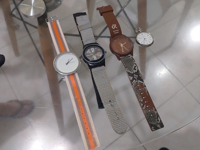 Assorted Wristwatches and Pocket Watch Bundle (Category: Men's Watches) located in Quezon City. Submitted by susmaryosep1 (Listing ID 1470789753, Image 3). Description: - Bundle of 4 diverse watches sold together as a complete set - 1x Striped silicone strap watch for casual wear - 1x Black tactical watch with a durable grey fabric strap - 1x Brown Burmese Python watch featuring a textured faux snakeskin pattern - 1x Small silver pocket watch for