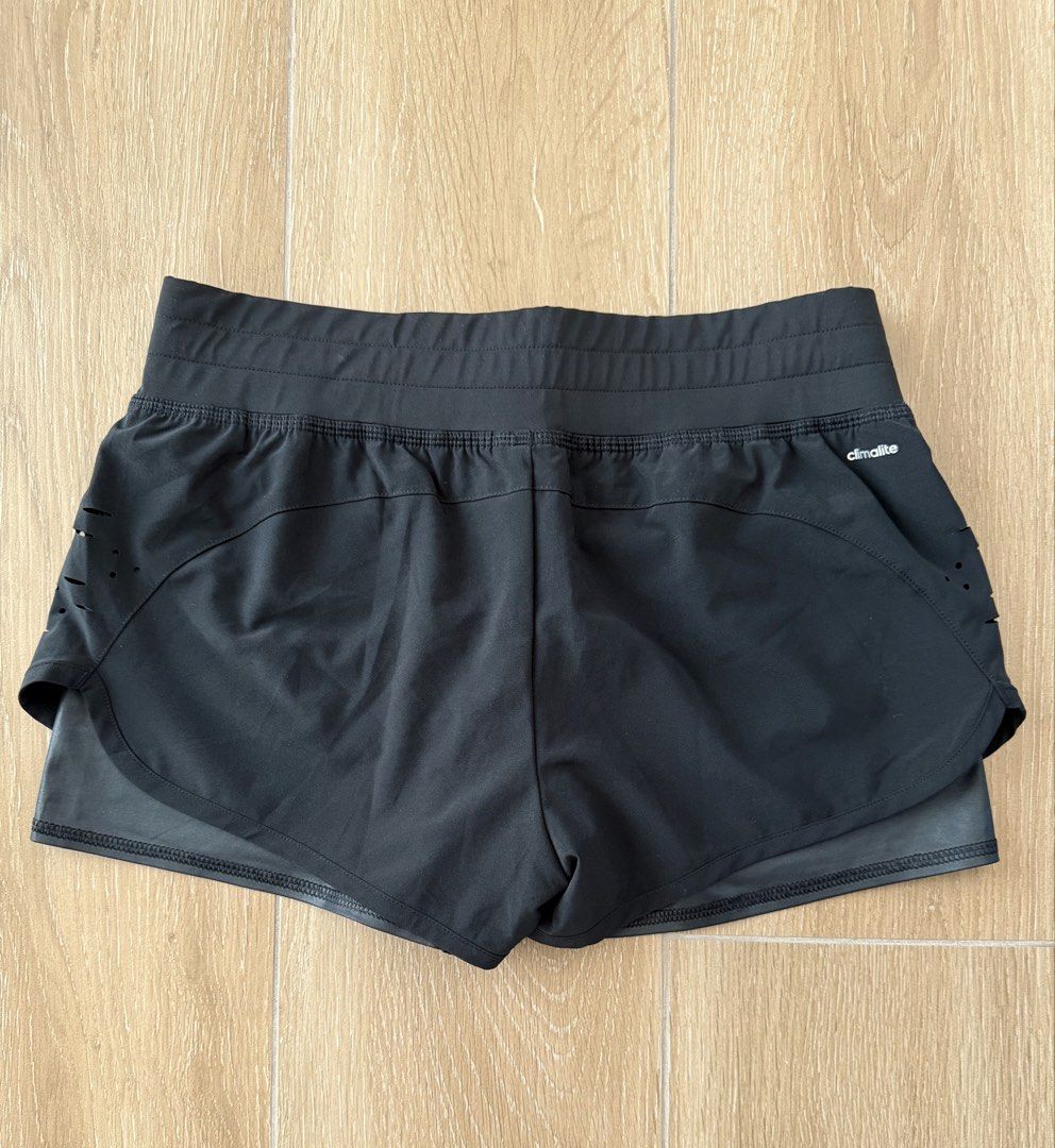 Authentic Adidas Climalite Black Athletic Shorts (Category: Shorts) located in San Fernando. Submitted by lovepreloved13 (Listing ID 1470767933, Image 3). Description: - Brand: Adidas - Color: Black - Size: Measures 14.5 inches across the waist (laid flat) - Material: Climalite fabric to keep you dry - Design: Double-layer with laser-cut ventilation on outer sides - Fit: Elastic waistband with internal drawstring - Logo/print is still very intact