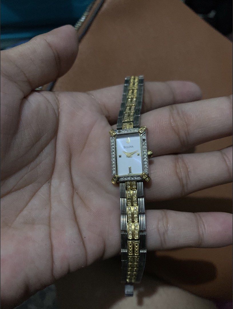 Authentic Bulova Two-Tone Crystal Watch — Complete with Box & Papers (Category: Women's Watches) located in San Juan, La Union. Submitted by declutteringog7 (Listing ID 1470844646, Image 1). Description: 🕰️ Authentic Bulova Two-Tone Crystal Watch — Complete with Box & Papers Price: ₱2,500 lp 📝 Details: • ✅ Brand: Bulova — Genuine / Authentic • ✅ Style: Elegant rectangular two-tone case with crystal accents • Mother-of-pearl dial • Classic vinta