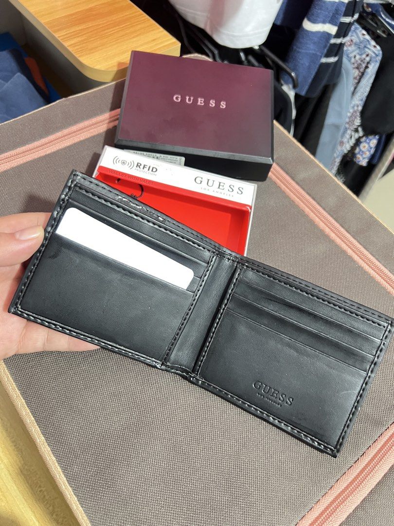Authentic GUESS Men's Bifold Wallet (Used / Read Description) (Category: Wallets & Card holders) located in Santa Rosa. Submitted by joselleferolino (Listing ID 1470844357, Image 3). Description: Selling an authentic GUESS Los Angeles Men's Bifold Wallet in Black. Features the classic red enamel triangle logo on the front. Comes with the original box and presentation tray. ⚠️ PLEASE READ BEFORE BUYING (Strictly No Returns): • This is a USED walle