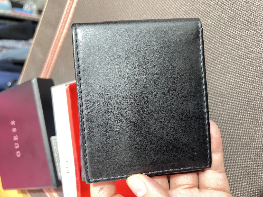Authentic GUESS Men's Bifold Wallet (Used / Read Description) (Category: Wallets & Card holders) located in Santa Rosa. Submitted by joselleferolino (Listing ID 1470844357, Image 2). Description: Selling an authentic GUESS Los Angeles Men's Bifold Wallet in Black. Features the classic red enamel triangle logo on the front. Comes with the original box and presentation tray. ⚠️ PLEASE READ BEFORE BUYING (Strictly No Returns): • This is a USED walle