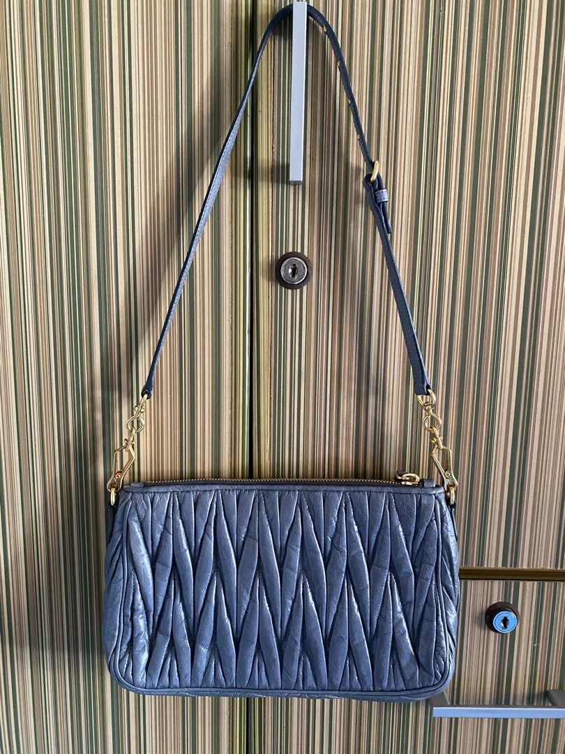 Authentic Miu Miu Matelasse Leather Shoulder Bag Blue (Category: Luxury Bags & Wallets) located in Taguig. Submitted by sandzclick (Listing ID 1470762772, Image 2). Description: - Authentic Miu Miu shoulder bag in a stunning soft blue matelassé leather - Elegant gold-tone hardware with a secure zip closure and cute side padlock charm - Features the iconic raised metallic Miu Miu logo on the front - Comes with an adjustable leather strap with poli