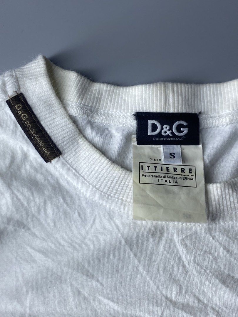 Authentic Y2k D&G Dolce & Gabbana Graphic Tee (Category: Announcements) located in Dagupan City. Submitted by vell25apparel (Listing ID 1470817232, Image 3). Description: - Brand: D&G Dolce & Gabbana - Color: White with large palm tree and floral front graphic - Size: Small (tag and Ittierre distribution label intact) - Details: Ribbed crew neck, short sleeves, and small D&G shoulder loop - Condition: Pre-owned with some yellowing around the coll