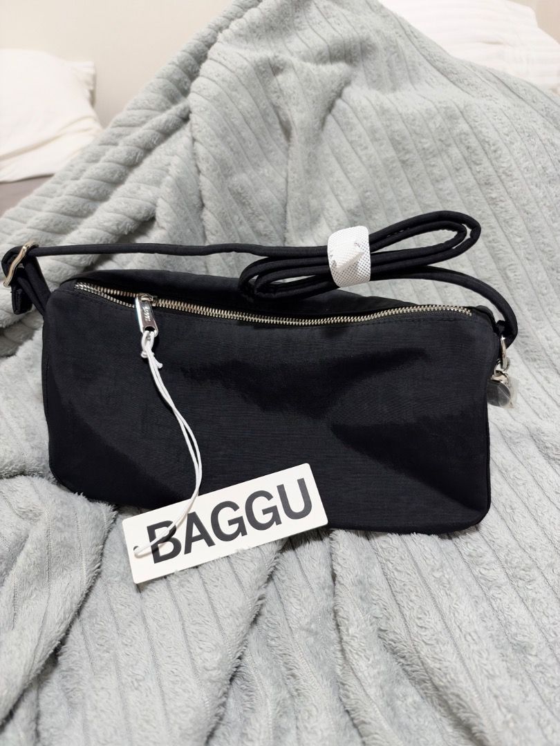 Baggu Nylon Loaf Bag Black (Category: Tote Bags) located in Quezon City. Submitted by kkkbm013 (Listing ID 1470827747, Image 1). Description: - Brand: Baggu - Style: Nylon Loaf Bag - Color: Classic Black - Condition: Brand new, never used, straight out of packaging with original hangtag attached - Features: Secure top zipper closure, adjustable strap with plastic protection - Bonus: Cute smiley face zipper pull charm (still wrapped in plastic) FR