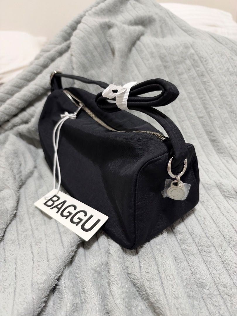 Baggu Nylon Loaf Bag Black (Category: Tote Bags) located in Quezon City. Submitted by kkkbm013 (Listing ID 1470827747, Image 2). Description: - Brand: Baggu - Style: Nylon Loaf Bag - Color: Classic Black - Condition: Brand new, never used, straight out of packaging with original hangtag attached - Features: Secure top zipper closure, adjustable strap with plastic protection - Bonus: Cute smiley face zipper pull charm (still wrapped in plastic) FR