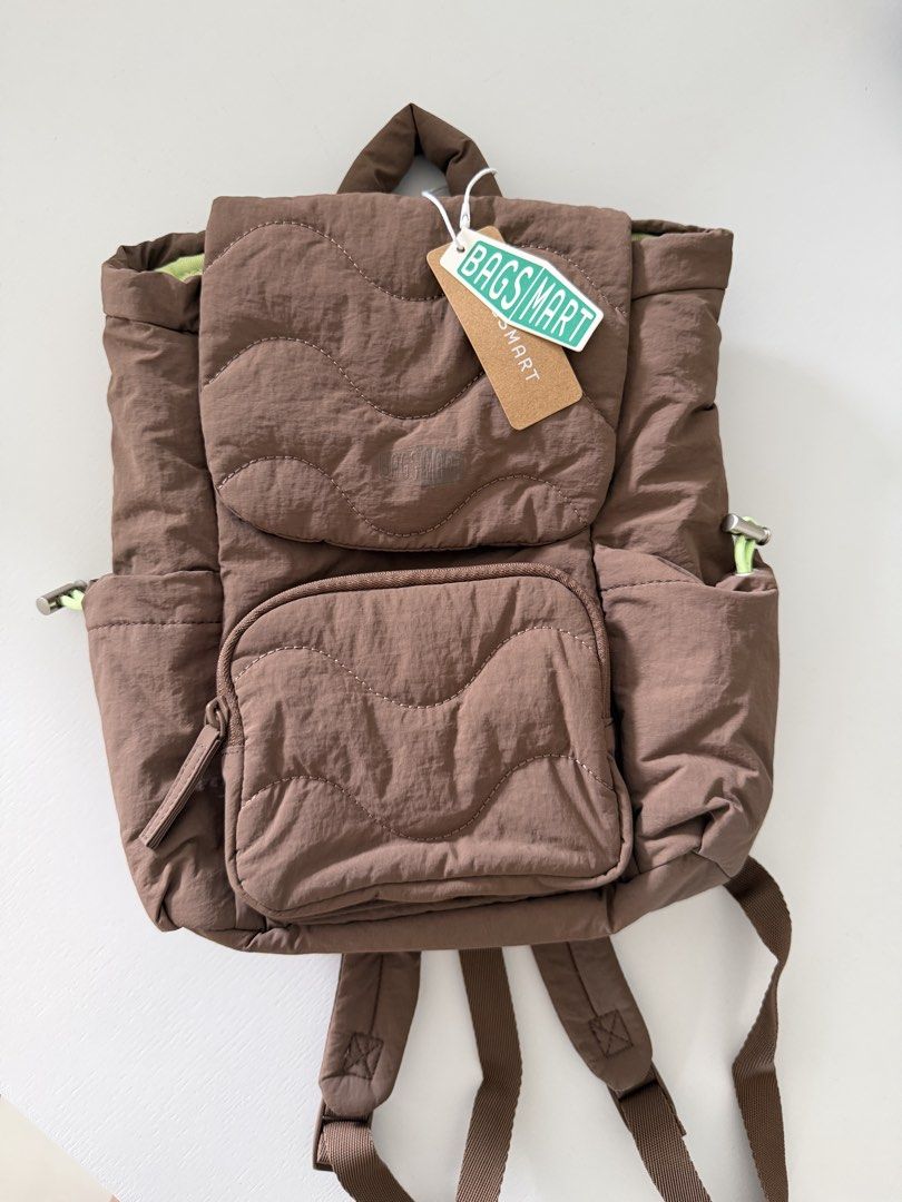 Bagsmart Quilted Brown Backpack with Lime Green Lining (Category: Backpacks) located in Cebu City. Submitted by jnnwright (Listing ID 1470926939, Image 1). Description: - Brand: Bagsmart - Color: Brown with lime green inner lining - Condition: Brand new with original tag attached - Design: Quilted wave pattern on the flap and front pocket - Closure: Drawstring and magnetic snap - Features: Multiple interior and exterior pockets, adjustable should