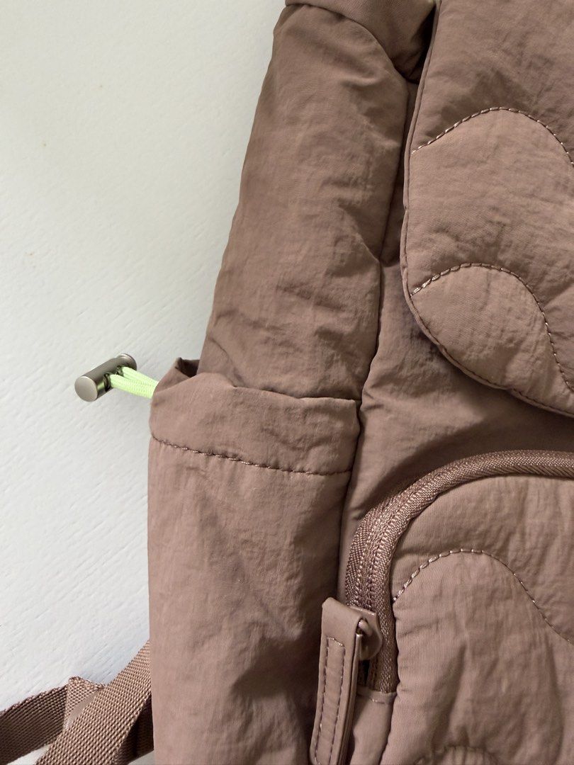 Bagsmart Quilted Brown Backpack with Lime Green Lining (Category: Backpacks) located in Cebu City. Submitted by jnnwright (Listing ID 1470926939, Image 3). Description: - Brand: Bagsmart - Color: Brown with lime green inner lining - Condition: Brand new with original tag attached - Design: Quilted wave pattern on the flap and front pocket - Closure: Drawstring and magnetic snap - Features: Multiple interior and exterior pockets, adjustable should