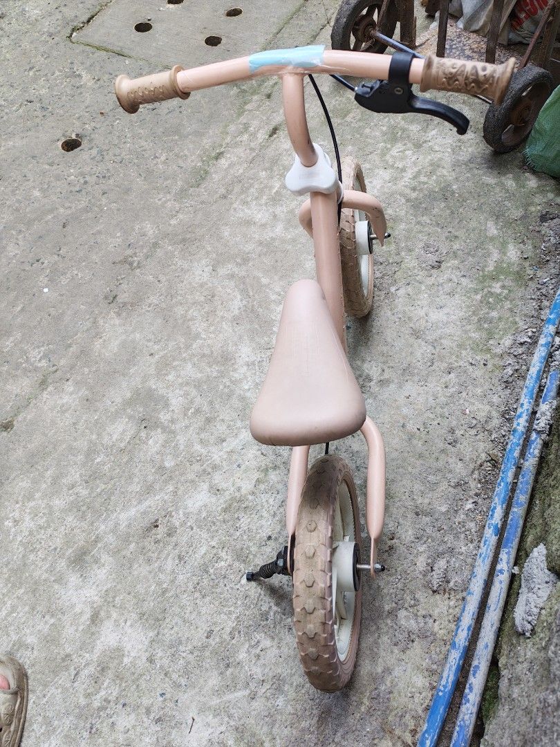 Balancing Bike Japan surplus (Category: Bicycles) located in Manila. Submitted by aks_japansurplus30 (Listing ID 1470901694, Image 3). Description: - Pink balance bike ideal for toddlers learning to ride - Features a handy handlebar handbrake and a black kickstand - Solid rubber wheels with stylish white rims - Adjustable seat height to grow with your child - Light pink frame with minor scuffs from outdoor play - Rubber handle grips show some dir