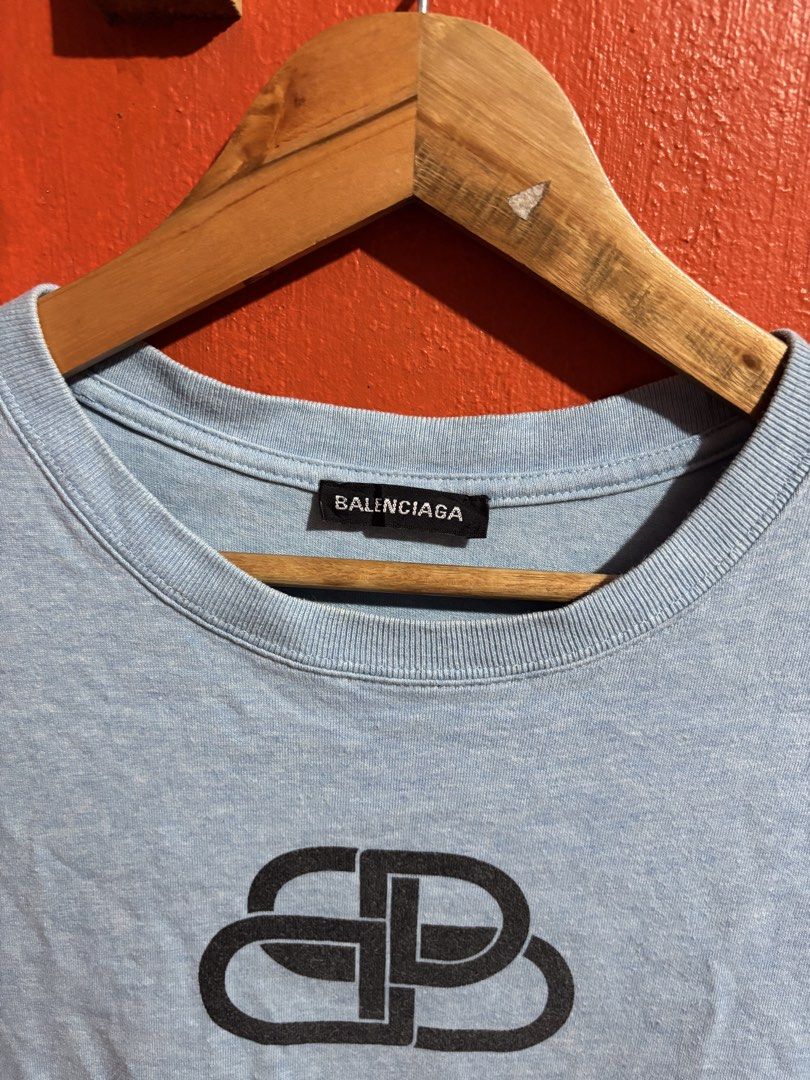 Balenciaga BB Logo Light Blue T-Shirt (Category: Luxury Apparel) located in Naga. Submitted by ajrc.shop (Listing ID 1470845949, Image 3). Description: Balenciaga Tshirt ✅Size: M ✅Width: 21 ✅Length: 27 ✅Color Rate: 9/10 ✅Issue: None ✅Need Wash ✅Location: Bicol Naga City, Camarines Sur ✅Courier: J&T Express/Flash Express ✅MOP: Gcash only.