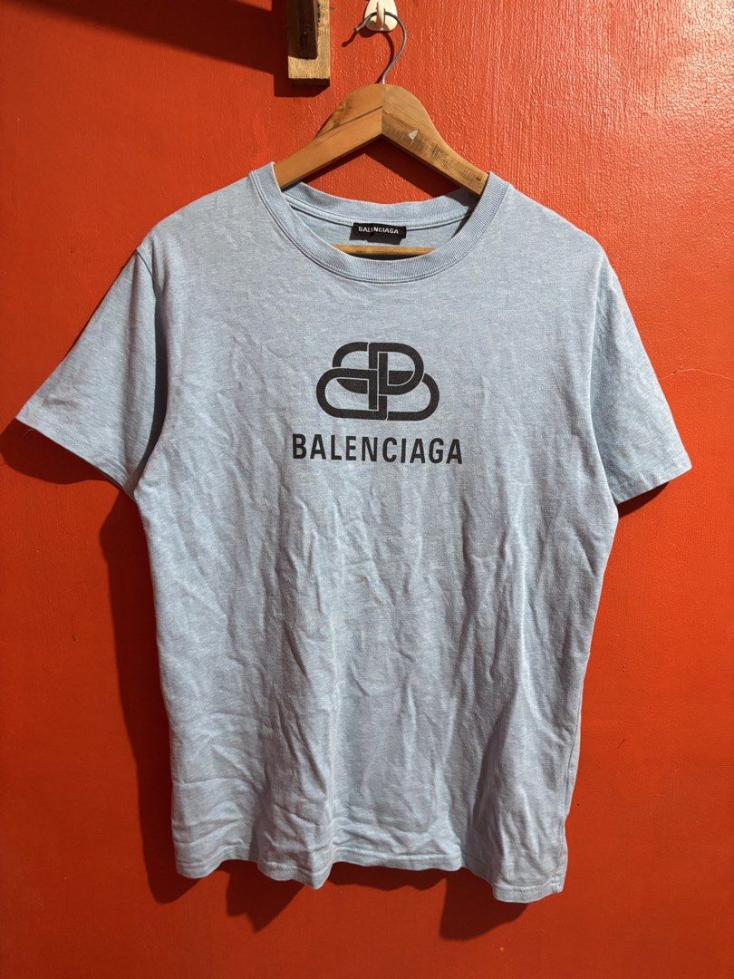 Balenciaga BB Logo Light Blue T-Shirt (Category: Luxury Apparel) located in Naga. Submitted by ajrc.shop (Listing ID 1470845949, Image 1). Description: Balenciaga Tshirt ✅Size: M ✅Width: 21 ✅Length: 27 ✅Color Rate: 9/10 ✅Issue: None ✅Need Wash ✅Location: Bicol Naga City, Camarines Sur ✅Courier: J&T Express/Flash Express ✅MOP: Gcash only.