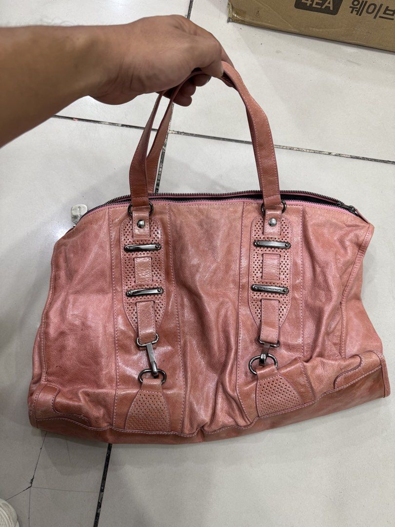 Balenciaga Pink Leather Handbag (Category: Luxury Bags & Wallets) located in Bacolod City. Submitted by kitcarsonduff (Listing ID 1470753157, Image 1). Description: - Balenciaga pink leather handbag - Chic perforated details and statement hardware accents - Convenient dual top handles and secure top zip closure - Spacious interior with black fabric lining - Includes Balenciaga Paris metal tag and serial numbers: N°0754C 115748 - Authenticity leat