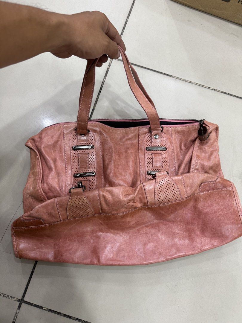 Balenciaga Pink Leather Handbag (Category: Luxury Bags & Wallets) located in Bacolod City. Submitted by kitcarsonduff (Listing ID 1470753157, Image 2). Description: - Balenciaga pink leather handbag - Chic perforated details and statement hardware accents - Convenient dual top handles and secure top zip closure - Spacious interior with black fabric lining - Includes Balenciaga Paris metal tag and serial numbers: N°0754C 115748 - Authenticity leat