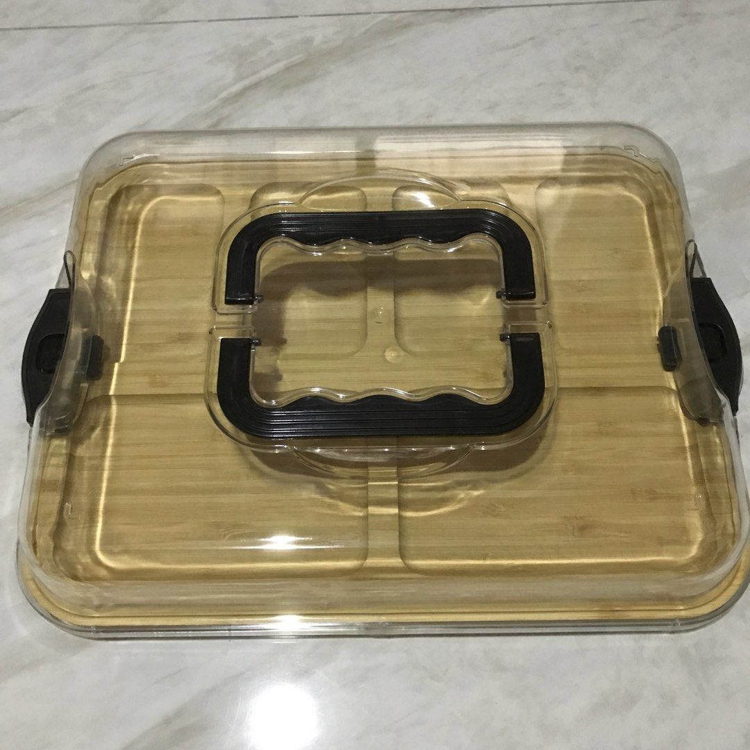 Bamboo Serving Tray with Clear Plastic Lid and Handle (Category: Food Organization & Storage) located in Manila. Submitted by magimi (Listing ID 1470849081, Image 1). Description: - Material: Eco-friendly bamboo wooden tray - Compartments: 6 divided sections for organizing various snacks or appetizers - Lid: Clear plastic cover with secure black locking clips on both sides - Portability: Built-in top handle on the lid for easy carrying - Inclusio
