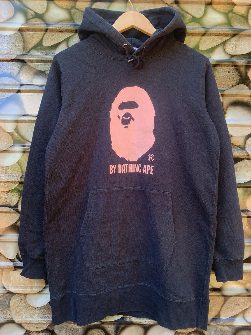 BAPE Pink Ape Head Ladies (Category: Coats, Jackets and Outerwear) located in Aloran. Submitted by chester78864 (Listing ID 1470931181, Image 1). Description: - Brand: A Bathing Ape (BAPE) - Item: Black Hoodie - Size: Small - Design: Large pink ape head graphic with "By Bathing Ape" text on the chest - Features: Kangaroo pocket, drawstrings with branded metal aglets - Details: Includes original interior neck tags and wash tags showing product cod