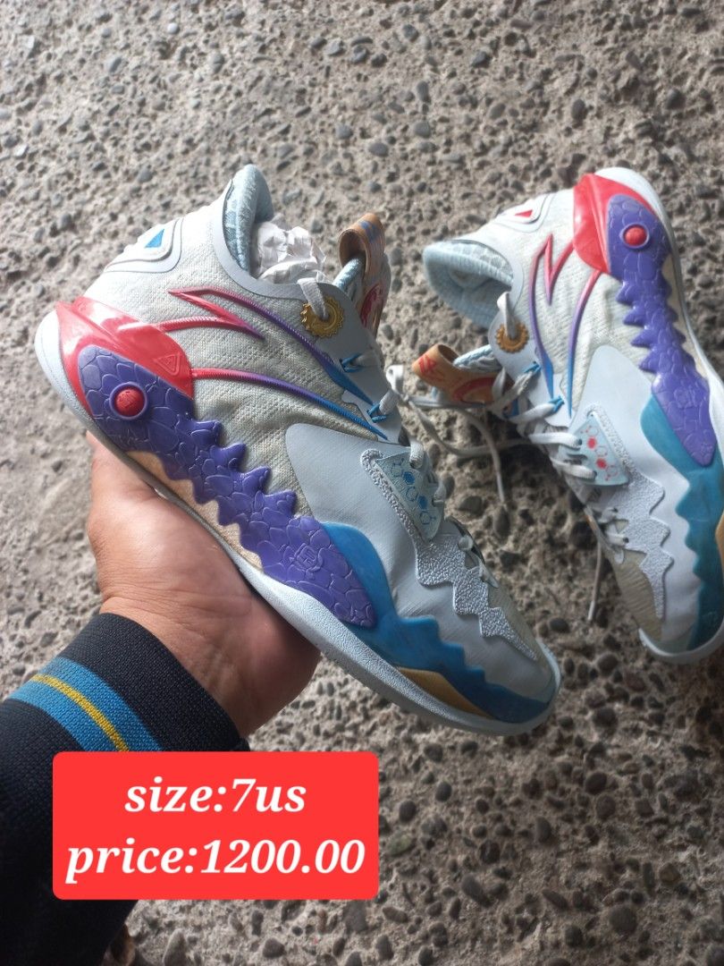 Basketball shoes size 7us multi-color (Category: Sneakers) located in Kalibo. Submitted by jofit2ndhandshoes (Listing ID 1470859709, Image 1). Description: - Colorway: Multi-color design with striking white, blue, purple, and red accents - Performance: Equipped with a visible carbon fiber shank plate for stability - Traction: Textured grip pattern on the bottom soles for optimal court control - Design: Secure laced closure featuring decorative to