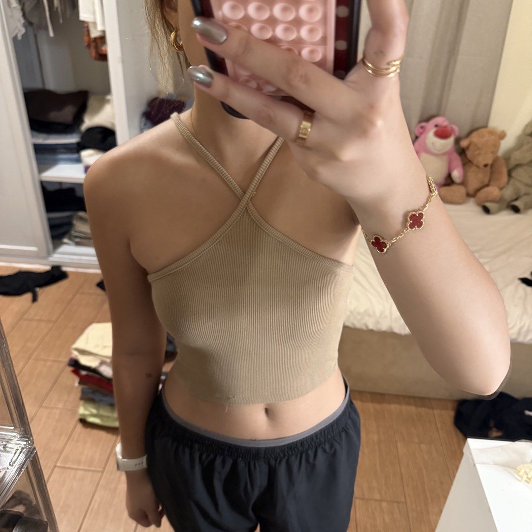 Beige ribbed halter neck crop top (Category: Sleeveless) located in Quezon City. Submitted by s0l4nge (Listing ID 1470881911, Image 2). Description: - Color: Beige - Style: Halter neck with trendy criss-cross straps - Material: Soft, stretchy ribbed knit - Fit: Form-fitting, cropped length - Condition: Clean and ready to wear.